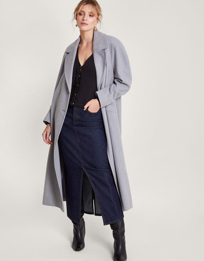 Woman in denim midi skirt with wool coat