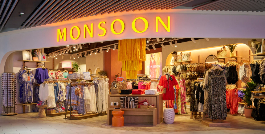 Shoppers browsing clothing rails at a sample sale fundraiser